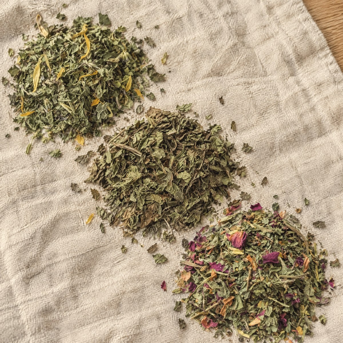 Three small piles of loose Wilsala tea on a linen towel